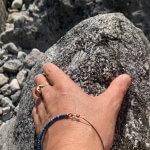 Hand auf einem Felsen als Symbol für Erdung und die stabile Mitte im Körper